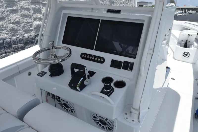 Slide: The Image of 2024 Yellowfin 36 Offshore boat console with dual screens and steering wheel. - 11