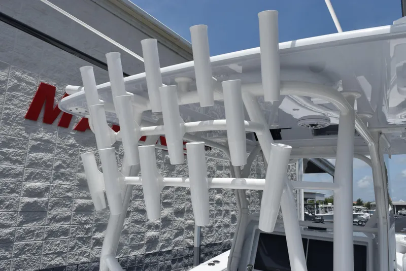 Slide: The Image of 2024 Yellowfin 36 Offshore boat with multiple white rod holders on the roof. - 14