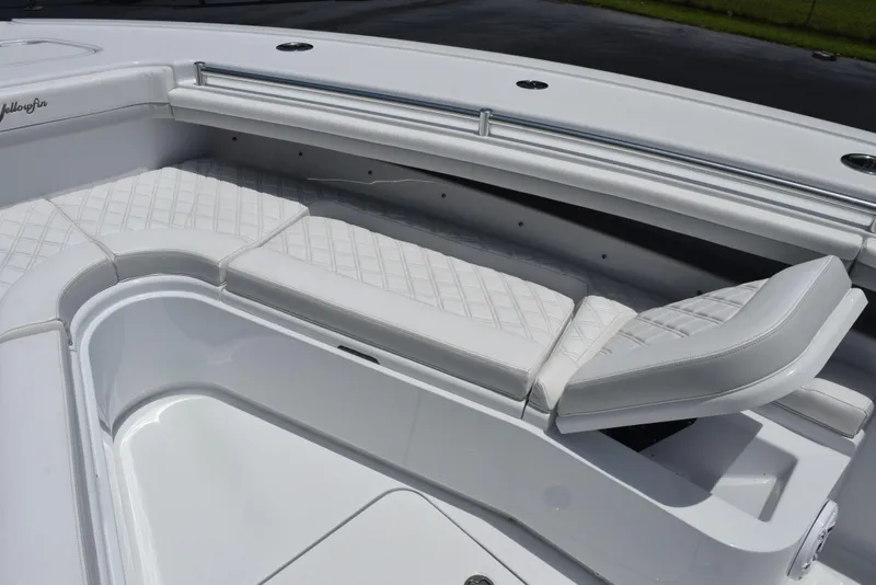 Slide: The Image of 2024 Yellowfin 36 Offshore boat with white cushioned seating and sleek design. - 16