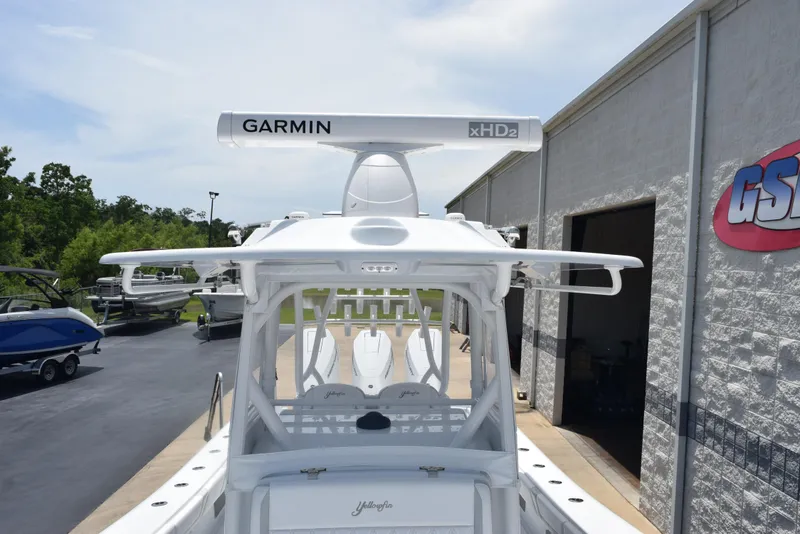 Slide: The Image of 2024 Yellowfin 36 Offshore boat with Garmin xHD2 radar, docked near a building. - 19