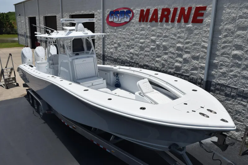 Slide: The Image of 2024 Yellowfin 36 Offshore boat displayed at a marine dealership. - 2