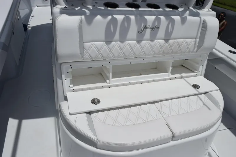 Slide: The Image of 2024 Yellowfin 36 Offshore boat with white cushioned seating and storage compartments. - 20
