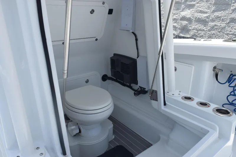 Slide: The Image of 2024 Yellowfin 36 Offshore boat interior with compact marine toilet. - 23