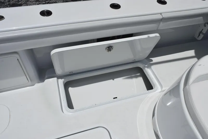 Slide: The Image of 2024 Yellowfin 36 Offshore boat storage compartment with open hatch, showcasing sleek design. - 33
