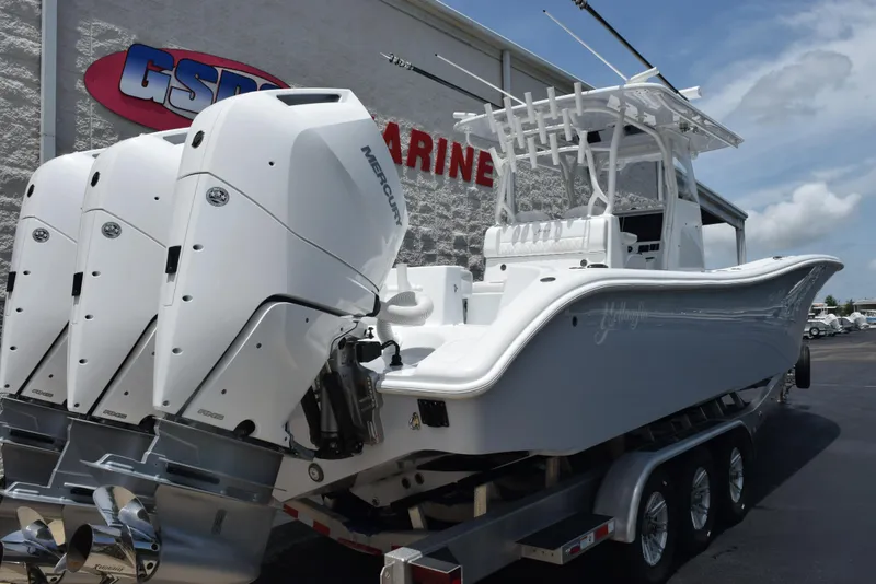 Slide: The Image of 2024 Yellowfin 36 Offshore boat with triple outboard engines on a trailer. - 4