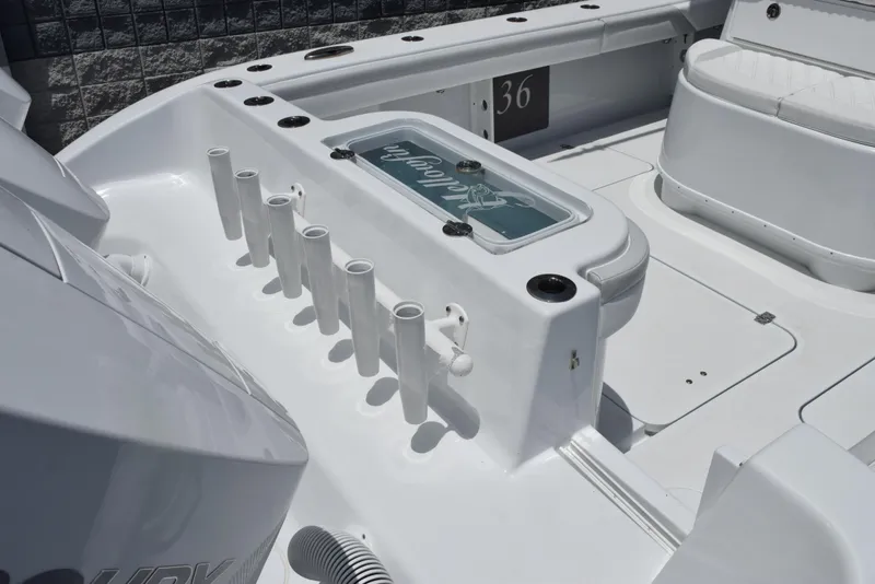 Slide: The Image of 2024 Yellowfin 36 Offshore boat deck with rod holders and seating area. - 8