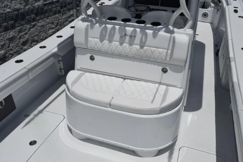 Slide: The Image of 2024 Yellowfin 36 Offshore boat with white cushioned seating and rod holders. - 9