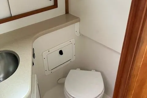 Slide: The Image of 2005 Back Cove Downeast Hardtop boat bathroom with sink and toilet. - 17