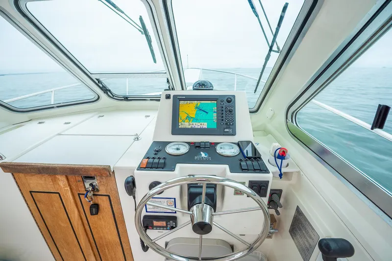 Slide: The Image of 2005 Back Cove Downeast Hardtop boat helm with navigation system and steering wheel. - 20
