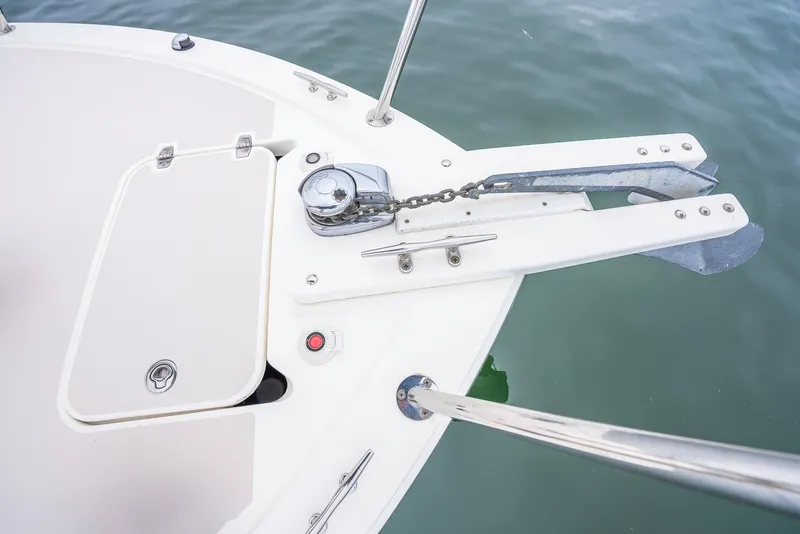 Slide: The Image of 2005 Back Cove Downeast Hardtop boat anchor and chain detail on calm water. - 25