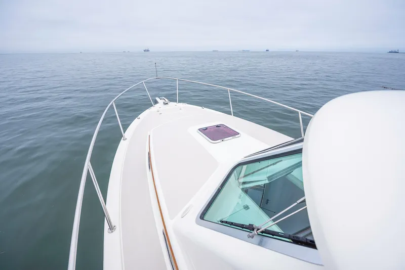 Slide: The Image of 2005 Back Cove Downeast Hardtop boat on calm sea, showcasing sleek design and open water. - 28