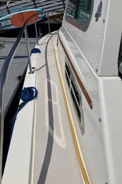 Slide: The Image of 2005 Back Cove Downeast Hardtop boat deck with railing and window details. - 31