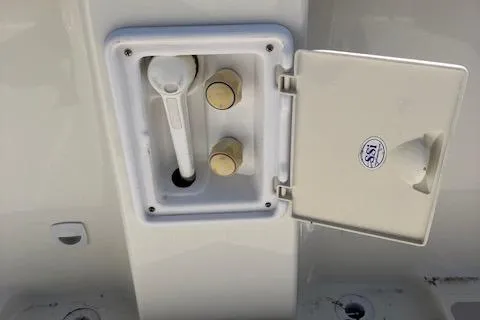 Slide: The Image of 2005 Back Cove Downeast Hardtop boat compartment with open hatch and controls. - 35