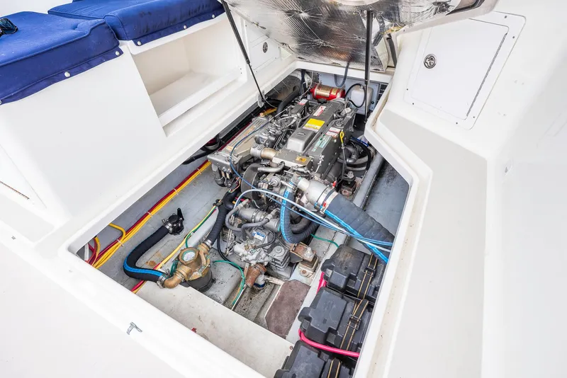 Slide: The Image of Engine compartment of a 2005 Back Cove Downeast Hardtop boat, showcasing mechanical components. - 37