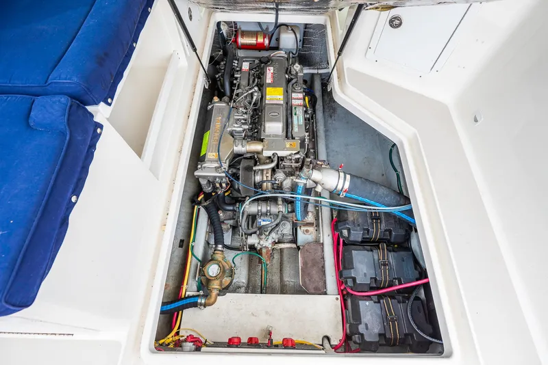 Slide: The Image of Engine compartment of 2005 Back Cove Downeast Hardtop boat, showcasing mechanical components. - 38