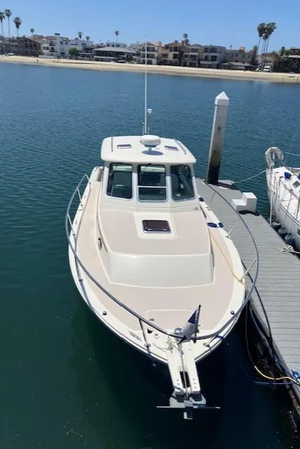Slide: The Image of 2005 Back Cove Downeast Hardtop boat docked in a marina with waterfront view. - 4