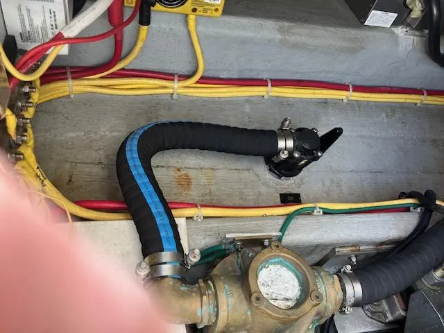 Slide: The Image of Engine compartment of a 2005 Back Cove Downeast Hardtop boat with visible wiring and hoses. - 41