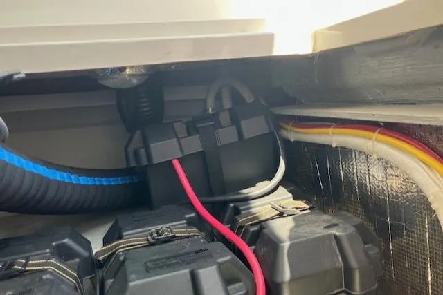 Slide: The Image of 2005 Back Cove Downeast Hardtop boat battery compartment with wiring and cables. - 42