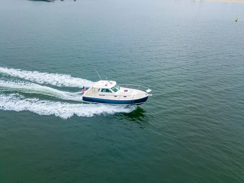 Slide: The Image of 2005 Back Cove Downeast Hardtop cruising on open water, aerial view. - 48