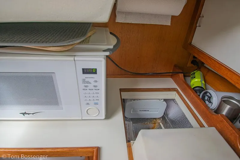 Slide: The Image of Microwave and storage area inside a 1992 Catalina 36 yacht kitchen. - 11