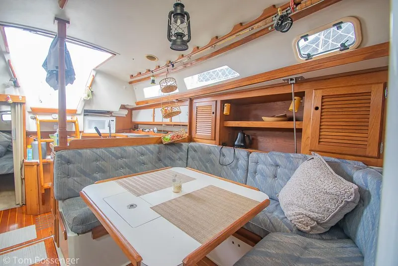 Slide: The Image of Interior of 1992 Catalina 36 sailboat with cozy seating and wooden cabinetry. - 13