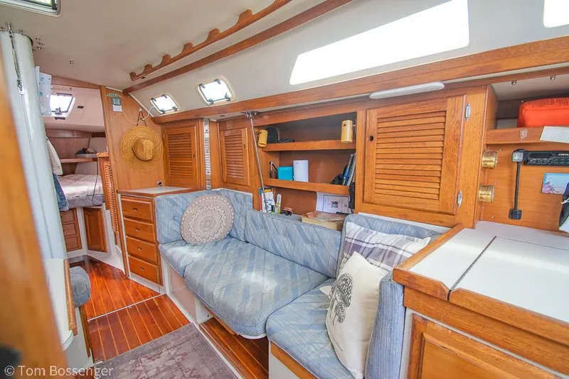 Slide: The Image of Interior of 1992 Catalina 36 sailboat with cozy seating and wooden cabinetry. - 15
