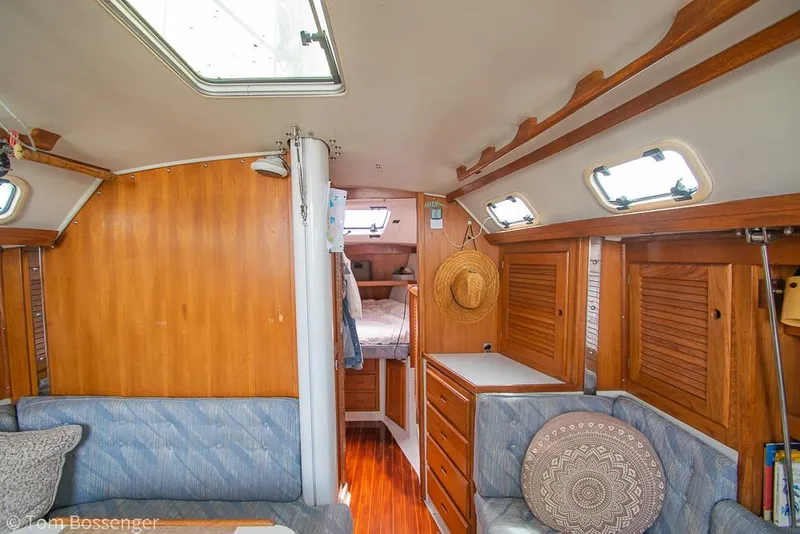 Slide: The Image of Interior of a 1992 Catalina 36 sailboat with cozy seating and wooden cabinetry. - 18