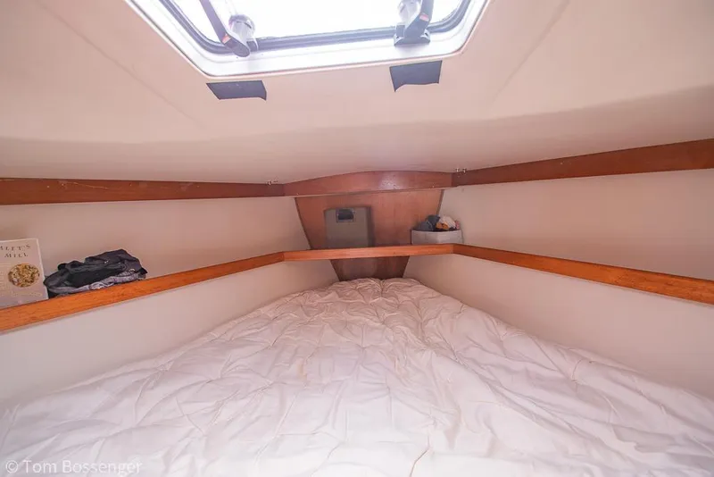 Slide: The Image of Cozy cabin interior of a 1992 Catalina 36 sailboat with a skylight and wooden accents. - 19