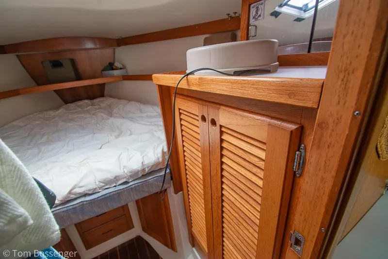 Slide: The Image of Cozy cabin interior of a 1992 Catalina 36 sailboat with wooden cabinetry and a bed. - 20