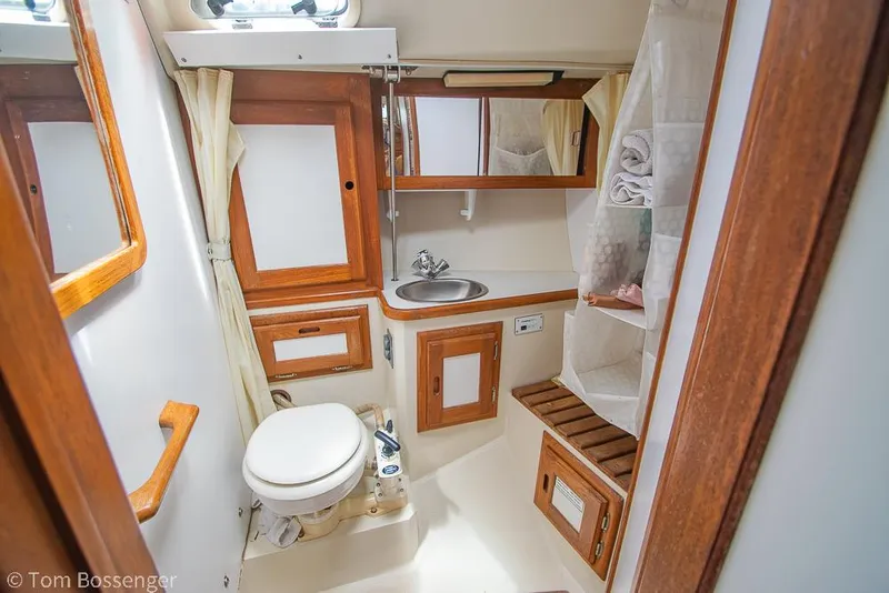Slide: The Image of Bathroom interior of a 1992 Catalina 36 yacht with wooden accents and compact design. - 21