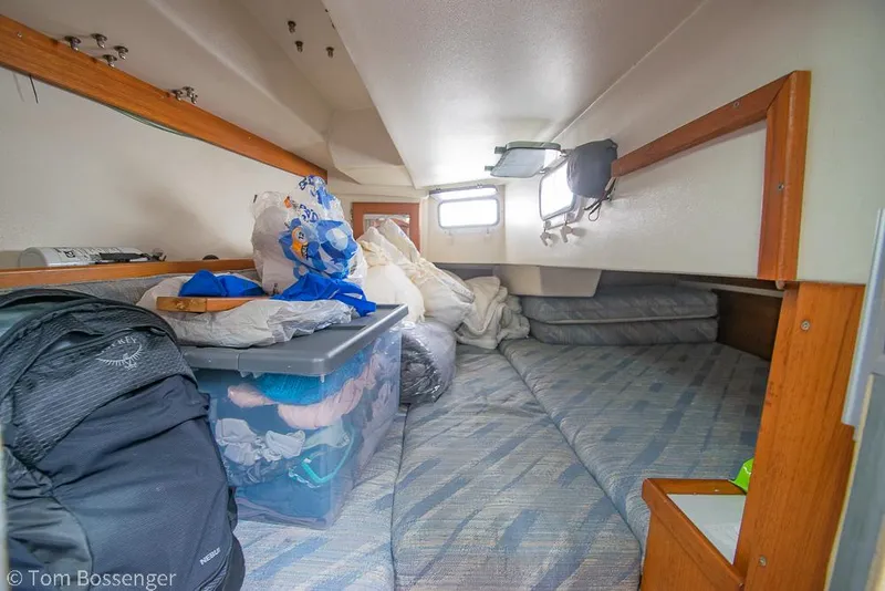 Slide: The Image of Cozy cabin interior of a 1992 Catalina 36 sailboat, featuring storage and bedding. - 22