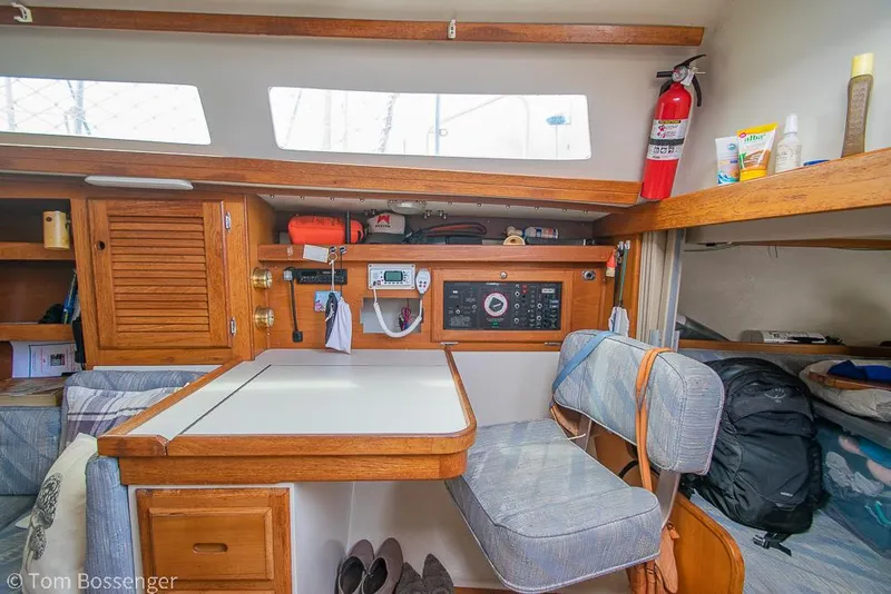 Slide: The Image of Interior of a 1992 Catalina 36 sailboat with dining area and navigation equipment. - 23