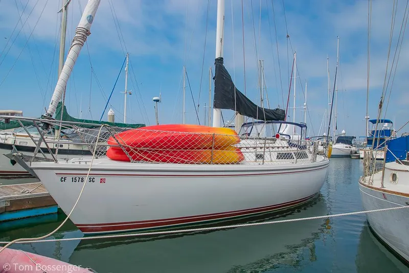 Slide: The Image of Sailboat Catalina 36, 1992 model, docked with kayaks on deck, clear sky background. - 3