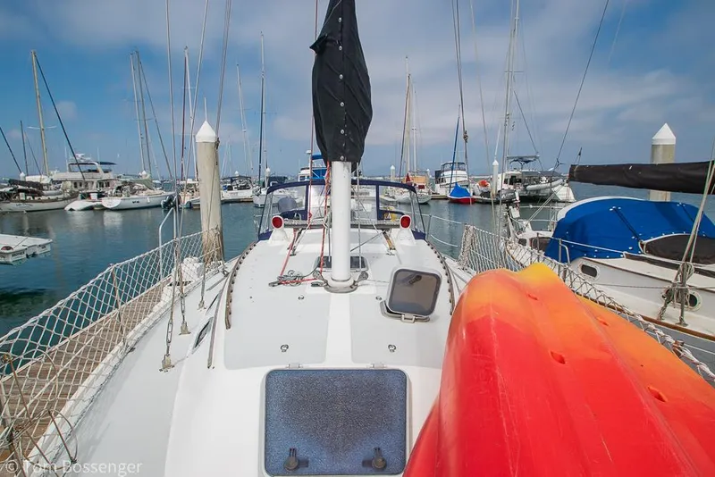 Slide: The Image of Sailboat Catalina 36, 1992 model, docked in a marina with kayaks on deck. - 42