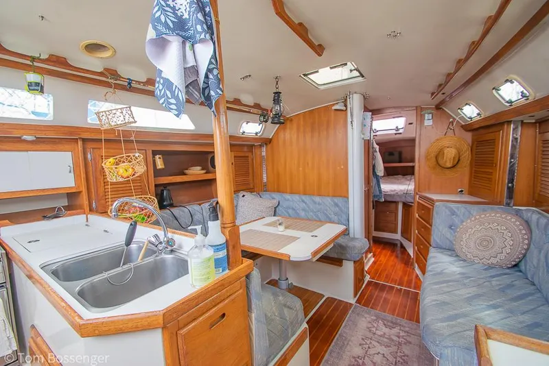 Slide: The Image of Interior of a 1992 Catalina 36 sailboat, featuring a cozy kitchen and seating area. - 7