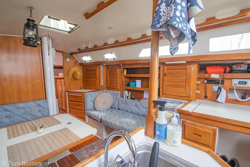 Slide: The Image of Interior of a 1992 Catalina 36 sailboat with cozy seating and wooden cabinetry. - 8