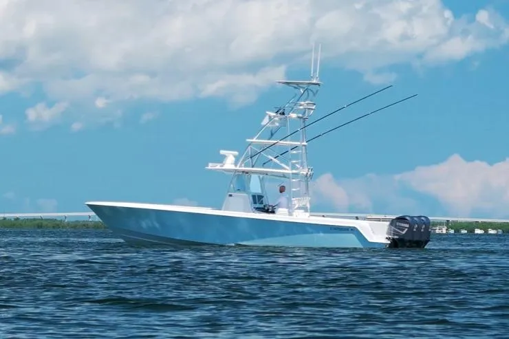 Slide: The Image of 2018 Contender 39 ST boat on water, clear sky background. - 0