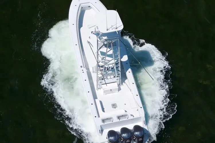 Slide: The Image of 2018 Contender 39 ST boat with triple engines cruising on water, aerial view. - 1