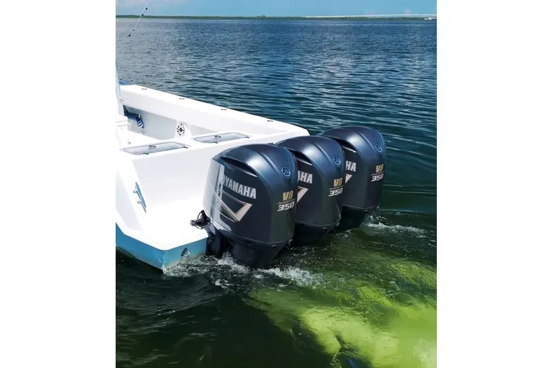 Slide: The Image of 2018 Contender 39 ST boat with triple Yamaha V8 350 outboard engines on water. - 11