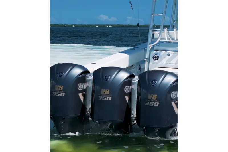 Slide: The Image of 2018 Contender 39 ST boat with triple Yamaha V8 350 outboard engines on water. - 2