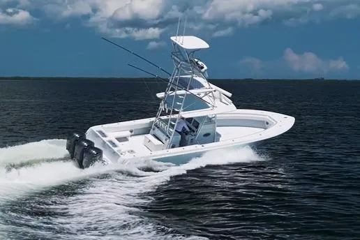 Slide: The Image of 2018 Contender 39 ST boat cruising on open water under cloudy skies. - 4