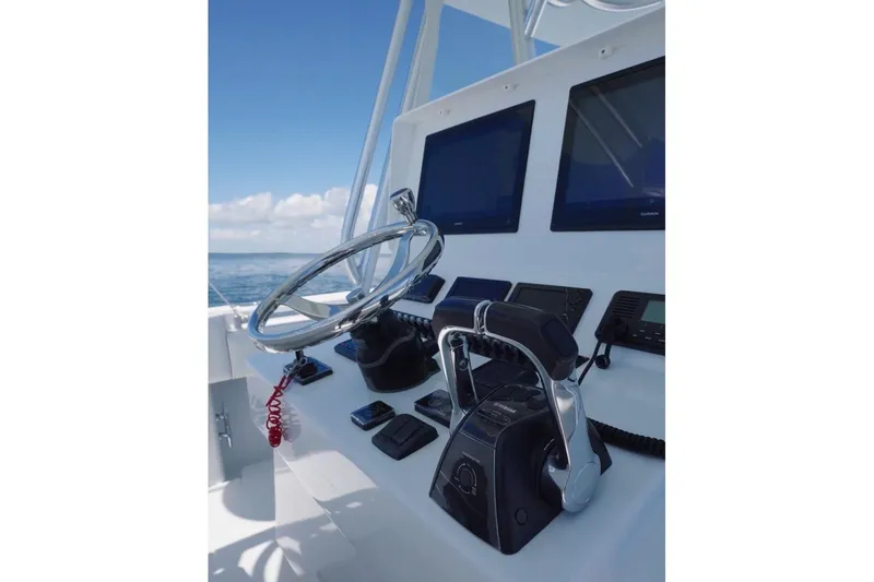 Slide: The Image of Helm of 2018 Contender 39 ST boat with steering wheel and navigation screens. - 7