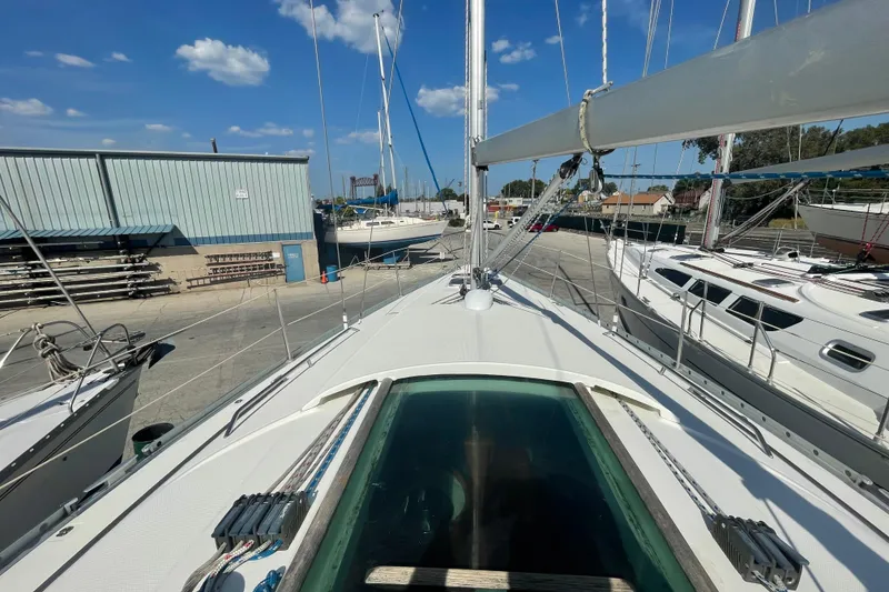Slide: The Image of 1996 Beneteau First 36s7 sailboat docked at marina under clear blue sky. - 10