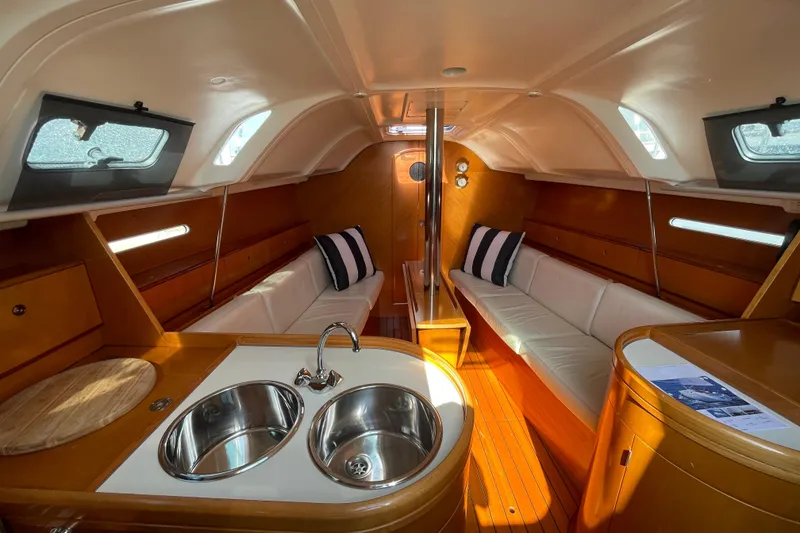 Slide: The Image of Interior of 1996 Beneteau First 36s7 sailboat with cozy seating and modern kitchen area. - 11