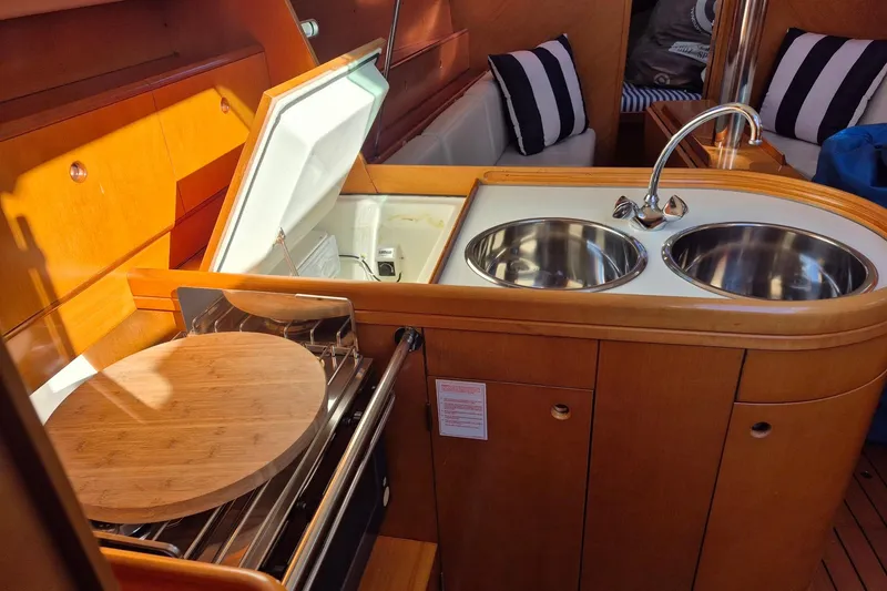 Slide: The Image of Interior of 1996 Beneteau First 36s7 yacht kitchen with dual sinks and stove. - 16