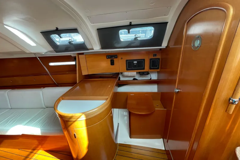 Slide: The Image of Interior of 1996 Beneteau First 36s7 sailboat with wood finish and seating area. - 19
