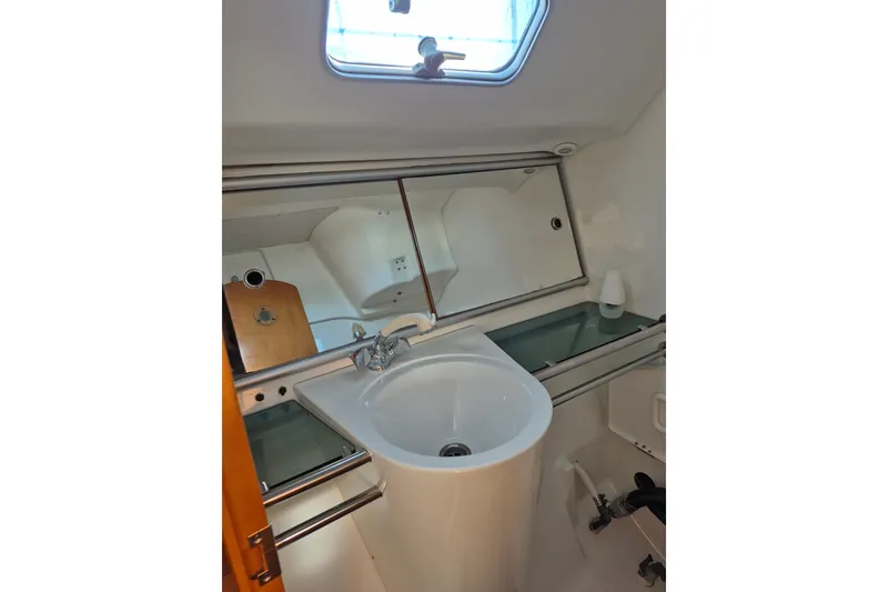 Slide: The Image of Bathroom interior of 1996 Beneteau First 36s7 yacht, featuring sink and mirror. - 23