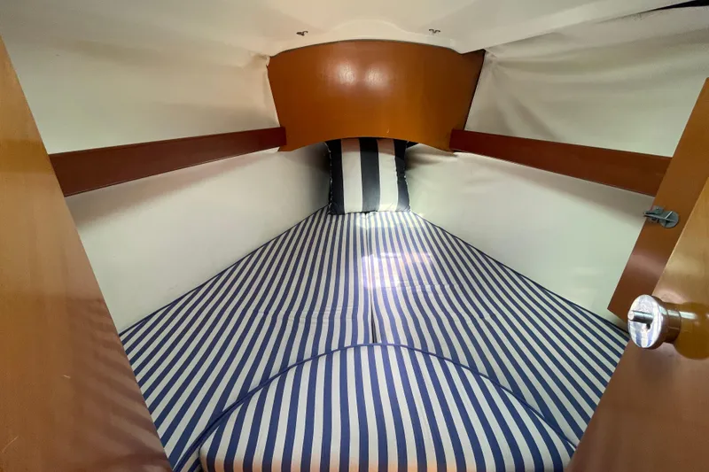 Slide: The Image of Cozy cabin interior of 1996 Beneteau First 36s7 with striped bedding. - 29