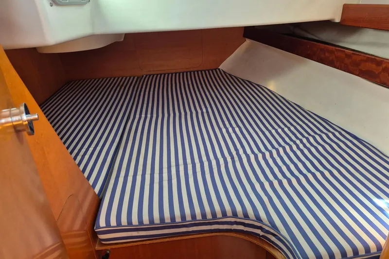 Slide: The Image of Beneteau First 36s7 1996 cabin with striped mattress, wooden interior. - 30