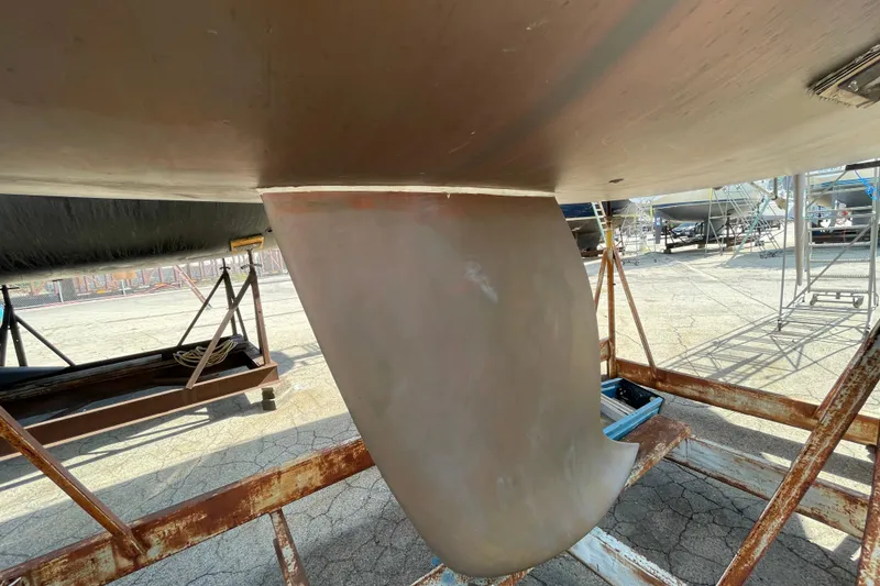 Slide: The Image of 1996 Beneteau First 36s7 sailboat keel on dry dock, showcasing hull structure. - 5